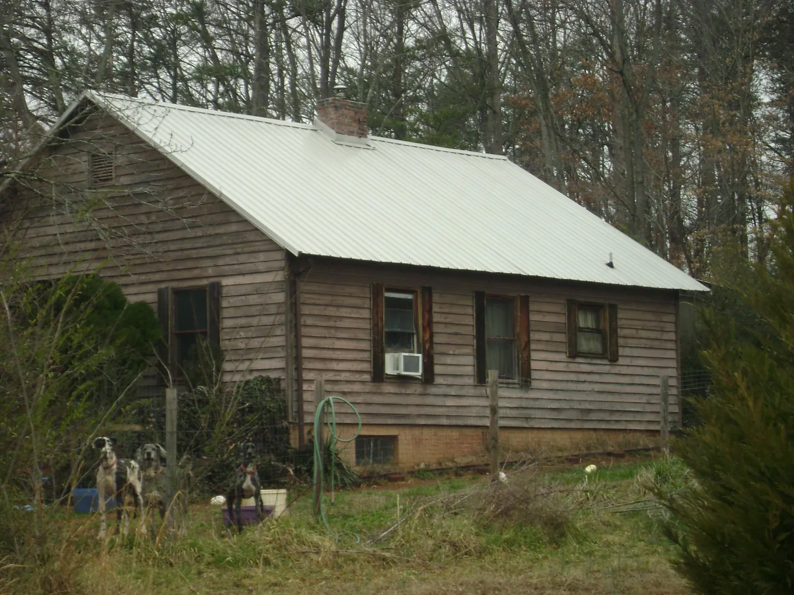 White metal roof on an old wood sided farmhouse, from a Metal Roof Installation job in Monroeville